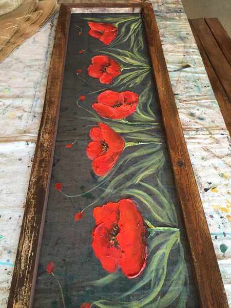 Fields of red poppieswith pallet wood frame